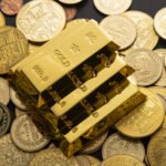 Shiny gold bars stacked in a vault representing gold’s market value and safe-haven demand.